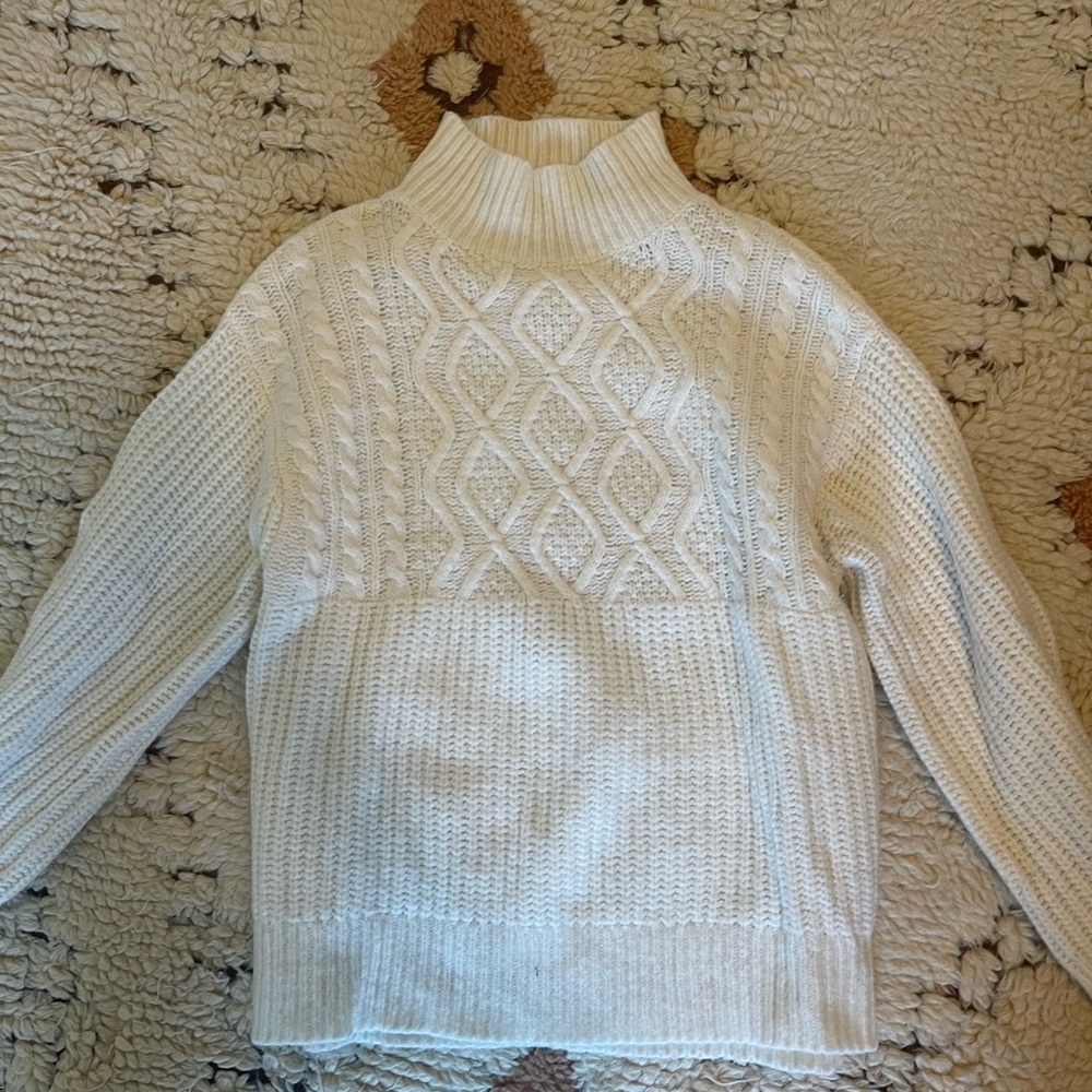 White turtle neck sweater.